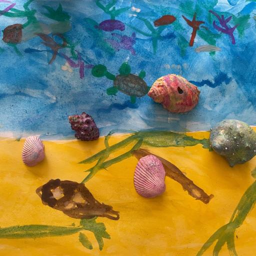 Painting of a beach with fish and shells